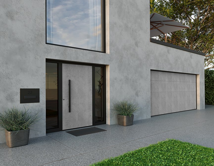 Brama garażowa z powierzchnia Duragrain i drzwi ThermoSafe Decoral w jednolitym wzorze jasny cement